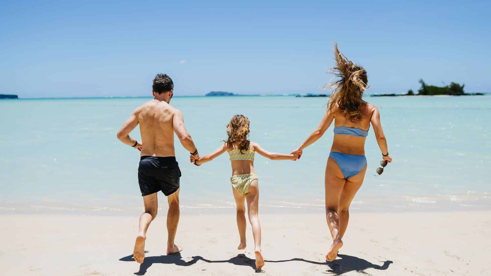 Family running on the beach